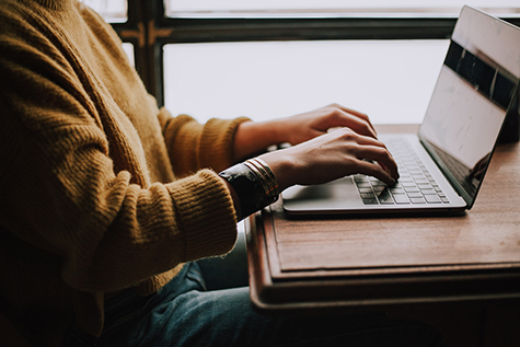 Person working on the computer, sitting at a desk
